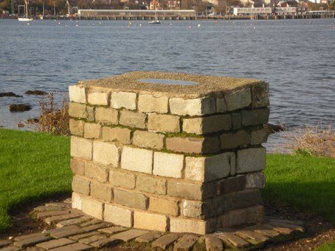 Battery Park ( Cairn ) –On Waterfront – 2012? Showing situation of Argyllshire Hills. Donated by Cardwell  / West Greenock Community Council